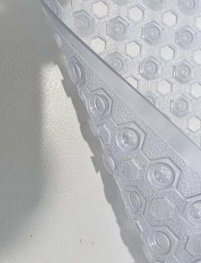 Non-slip bath mat with suction cups placed inside bathtub for traction