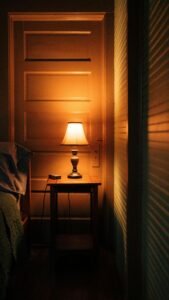 Warm and cozy bedroom with an electric lamp on a night table creating a serene atmosphere.