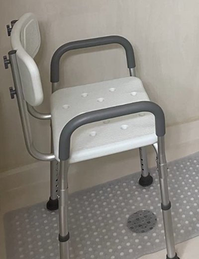 Shower chair with back and armrests providing seated support for seniors