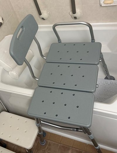 Transfer bench positioned across bathtub to assist safe entry and exit